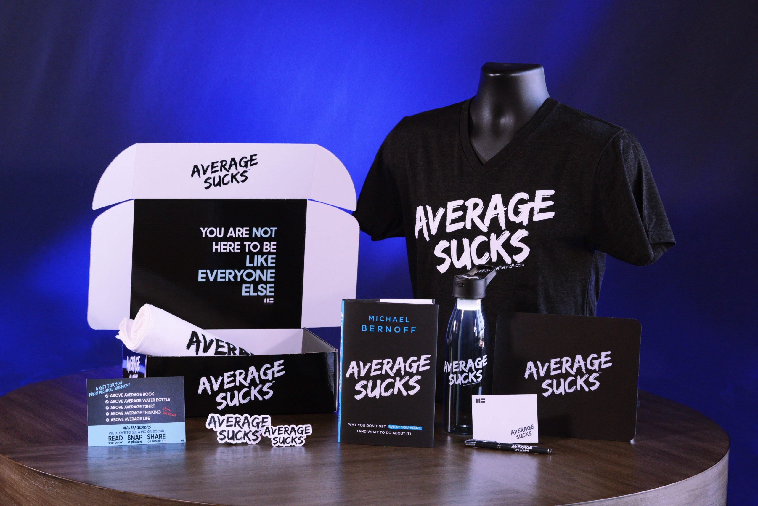 Average Sucks book, custom box, and merch 