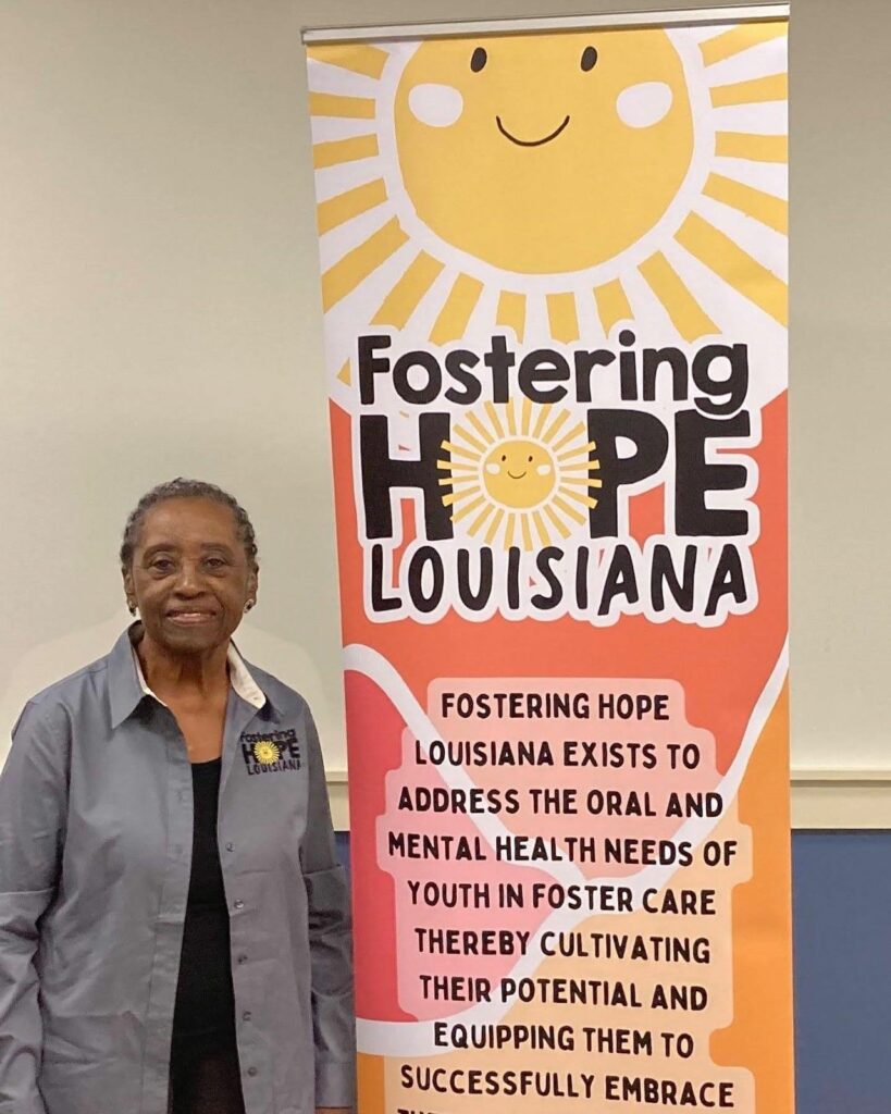 lady poses beside colorful retractable banner